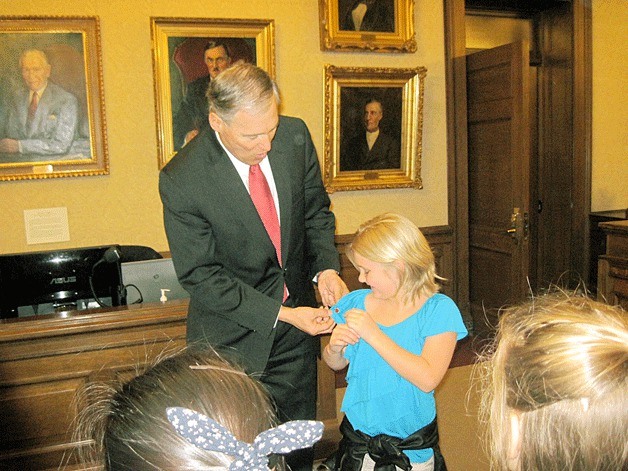 Gov. Jay Inslee recognizes Bothell resident Cara Long in Olympia.