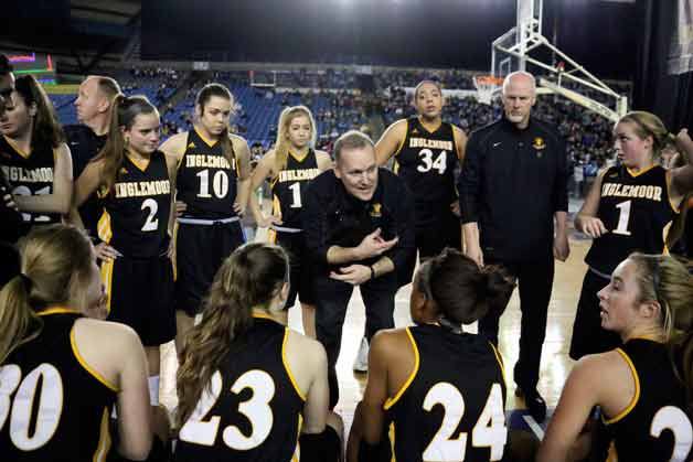 Inglemoor High School girls basketball head coach John Augustavo talks with the Vikings during a timeout at the state tournament in the Tacoma Dome.