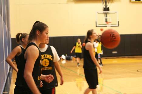 Inglemoor High sophomore Taylor Peacocke concentrates before grabbing the bouncing ball during a shooting drill last Thursday during practice. She scored 36 points in a recent victory over Juanita.