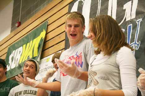 Bothell High football player Michael Hartvigson jokes with Cougar volleyballer Rachael Davis following Thursday's Subway sandwich-building contest during lunchtime at Bothell High. Geoff Watson looks on from the left.