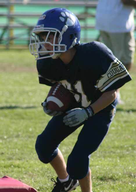 Patrick Armstrong runs the ball during the Bothell Cougars Rookie Blue team's Aug. 18 practice at Pop Keeney Field.