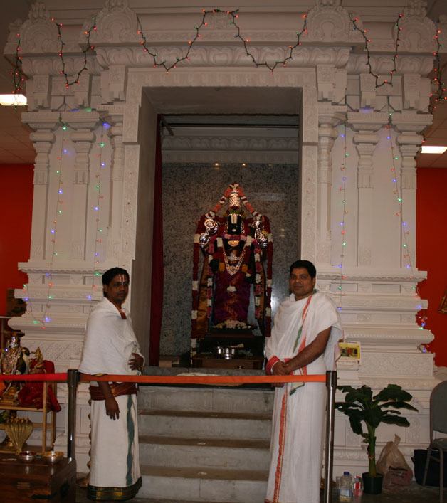 Priests stands in front of a new idol delivered to the Hindu Temple and Cultural Center in Bothell last week.
