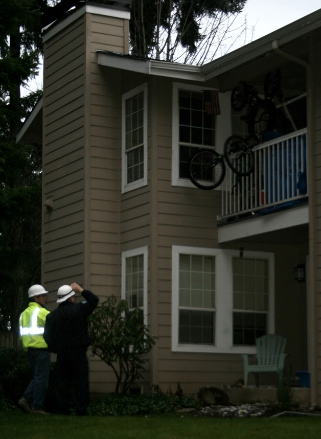 Fire investigators survey the damage from an explosion and fire Wednesday night.