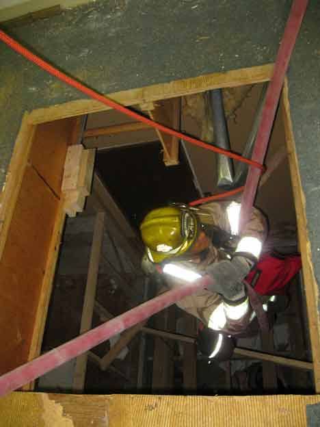 Bothell firefighter Jason Emerson gets a lift during a recent training session at the old Hopelink building.