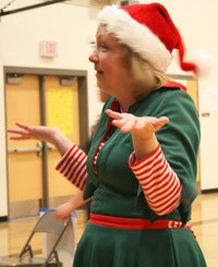 Norma Stoutenburg plays the role of Mrs. Claus by getting children to smile for their pictures with Santa at last year's Northshore Rotary Santa Breakfast.