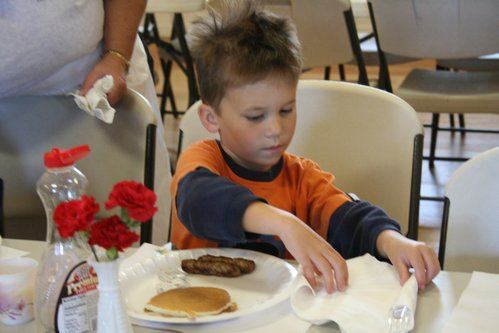 Devin Marsh of Bothell carefully rolls out his napkin and prepares to chow down at this morning's Community Pancake Breakfast at the Kenmore Community Center.