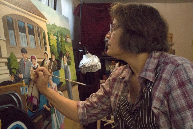Michelle Waldele-Dick paints a scene for the new McMenamins Anderson Building. She has been a Bothell resident and active part of the local artist culture for many years.