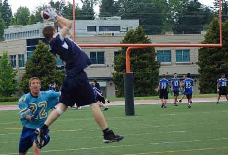 Cedar Park Christian's Zach Dinsmore catches a pass from Justin Girgus at the passing tournament.