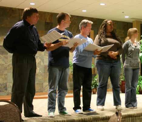 Several cast members of the Attic Theatre’s latest musical production get ready to rehearse one of the play’s several songs. They are