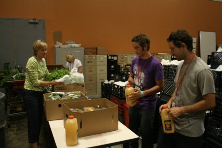 Hopelink Public Relations Specialist Denise Stephens helps sort food with volunteers at the new facility in Kirkland.