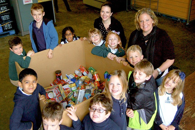 Ellie Sivesind stands with her second grade class from Evergreen Academy at Hopelink. Sivesind helped organize the donation of 1