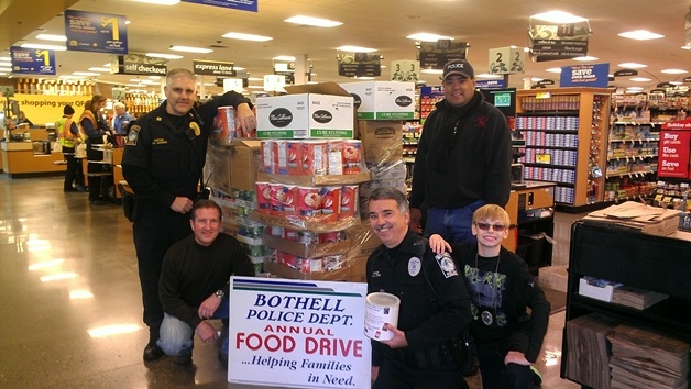 Two pallets of groceries were purchased by a local businessman from the Canyon Park QFC FreeDoc and given to the Bothell Police Department in support of HopeLink for the annual food drive done in partnership with Bothell residents. From left