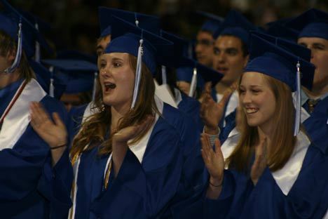 Bothell High's Katelyn Barrows and Sarah Bechler cheer at the end of their graduation ceremony Wednesday night at the University of Washington.