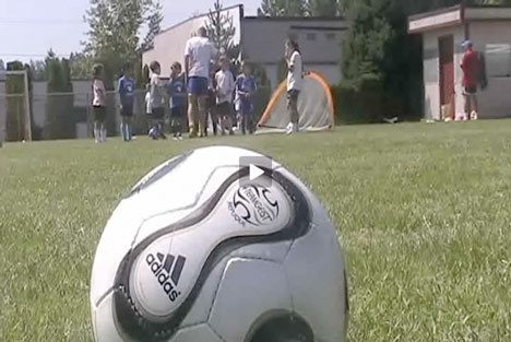 A soccer ball rests on a field during a Bothell High kids soccer camp.