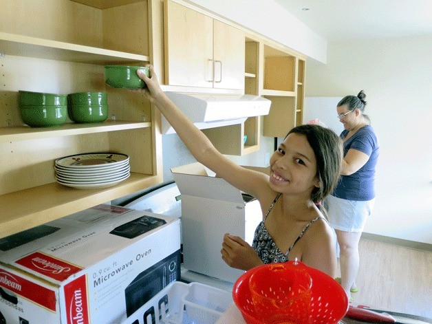 Local 10-year-old Angel helps her mom Renay Ferguson move into their new apartment.