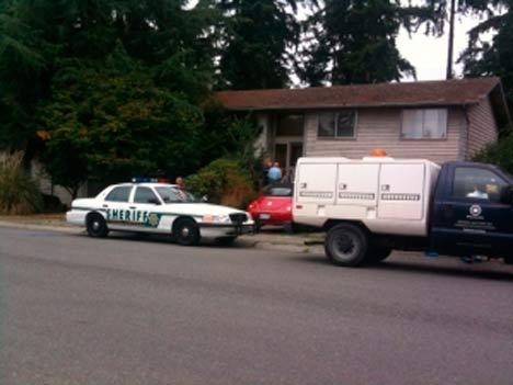 Police officers and Animal Care and Control members parked outside of the Bothell home where they removed six dogs Friday morning.