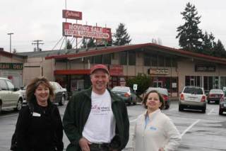 Standing in the parking  lot they hope will be filled with their customers for a long time to come are Kenmore Village business owners