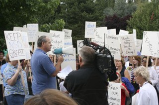 Northshore Education Association President Tim Brittell addresses picketers outside the Northshore School District headquarters Aug. 20.