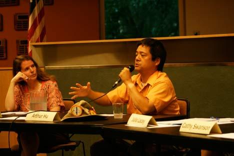 School-board candidate Arthur Hu makes a point while District 4 board candidate Sandy Hayes listens at a recent forum.