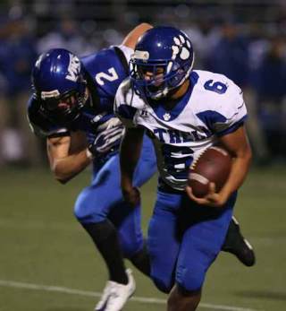 Bothell High's Patrick Ottorbech rushes past the Curtis High defense in last Saturday's win.