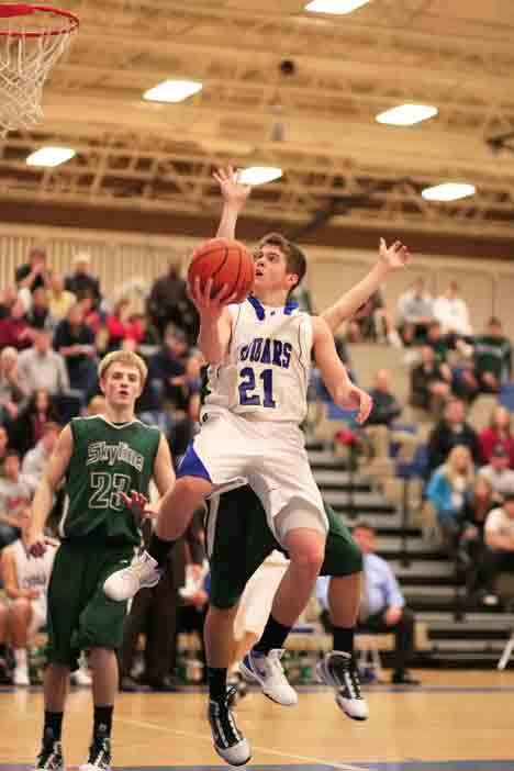 Bothell High’s Oliver Hurtin drives to the hoop in the Cougars’ 57-54 overtime win over Skyline High Dec. 15.