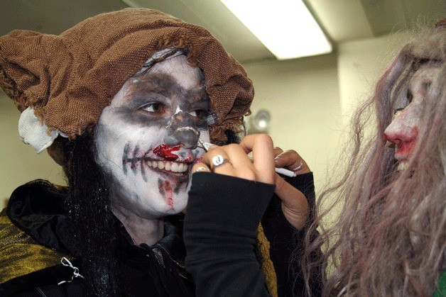 Bastyr University student Breanna Vick has a friend help her with makeup as she prepares to take part in Haunted Trails on the school’s campus in Kenmore. Haunted Trails is in its 14th year and just one of the many Halloween events taking place around the city.