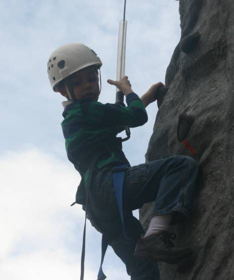 A young climber concentrates as he descends the 32-foot Northshore Summit rock wall Saturday morning during Northshore YMCA's Healthy Kids Day. He reached the top.