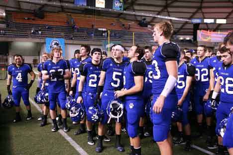 Bothell High football players chant with the crowd following the Cougars’ 31-26 loss to Skyline High last Saturday night in the 4A state semifinals at the Tacoma Dome. Players include Kevin Sayson