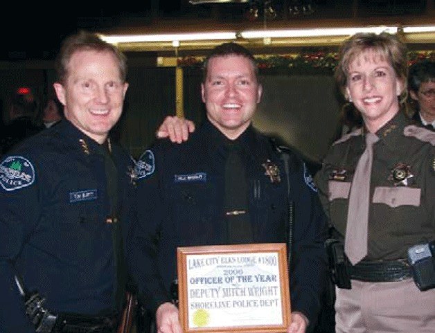 Then-King County Sheriff Sue Rahr recognizes then-Deputy Mitchell Wright (center) as Shoreline Police Officer of the Year in 2006 for making more than 150 arrests