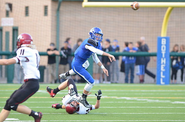 Bothell quarterback Jacob Sirmon avoids a tackle and gets a pass off against Eastlake on Friday.