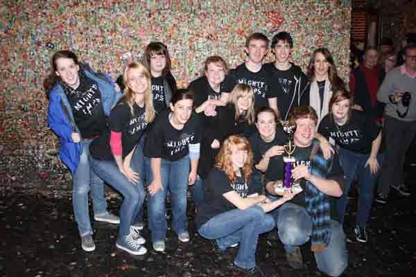 Bothell High's Mighty Imps in front of the famous Gum Wall outside the Market Theater in Seattle. Front row kneeling and holding trophy: Kara Bartlow and Austin Ascanio. Middle row: Audrey Michael