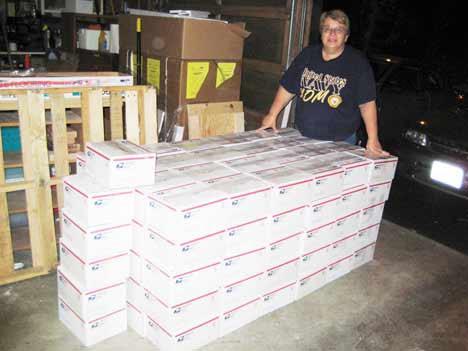 MaryJo Bader of Bothell prepares to send 130 care packages to sailors