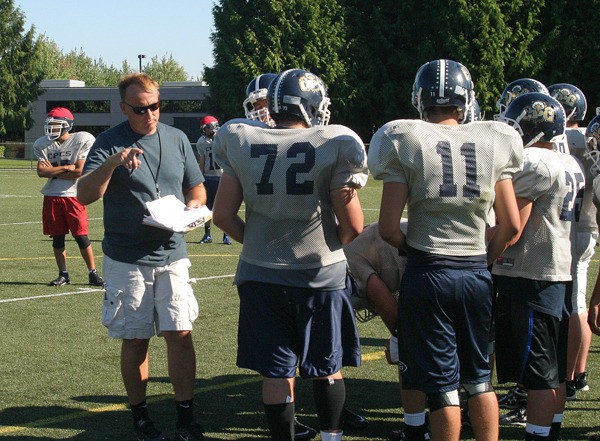 First-year head coach Todd Parmenter of the Cedar Park Christian Eagles instructs his players during offensive drills at North Creek Sportsfields in Bothell. The Eagles kick off their season on Friday on the road in Granite Falls.