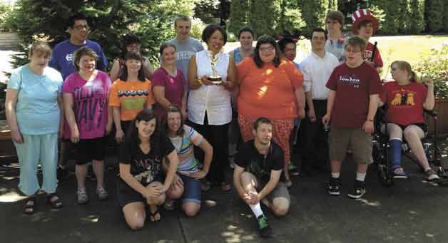 Wranglers Music instructor Bernadette Bascom celebrates her Emmy with the Northshore Wranglers Singing Program.