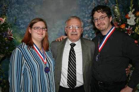 Cascadia Community College students Athena Mace and Patrick Connors with college President Dr. William Christopher after receiving their medals at the 2010 All-Washington Academic Team during a ceremony at South Puget Sound Community College.