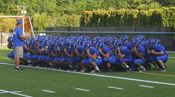 Bothell head coach Tom Bainter rallies the troops before a recent practice at Pop Keeney Stadium. The Cougars get their 2011 season underway at home on Friday night against Union