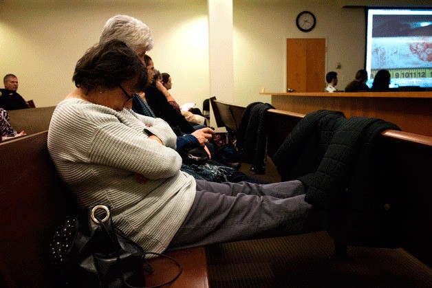 Family members of the victim look away during the most gruesome of photographs during the trial. In the background and right