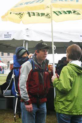 Scott and Michelle Kono brave the rain with a beer sample and their son