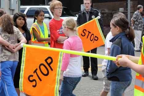 Bhargavi Kantipudi (in yellow vest) leads Ben Dossett (red shirt) and others while Joey Grant (black jacket) with the King County Explorers looks on during Summer Safety Patrol Academy training June 29 at Kenmore Junior High. Also pictured next to Kantipudi is Ashiana Dhanani. The academy was held June 28-29 for fifth- and sixth-graders who will be serving as safety patrol officers for the 2010-11 school year. More than 200 students participated in the training.  The academy is held in partnership with the Kenmore Police Department and King County Explorers.