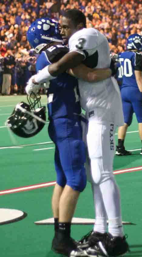 Bothell High's Luke Proulx and Skyline High's Kasen Williams embrace following the Cougars' 25-20 victory Oct. 29.