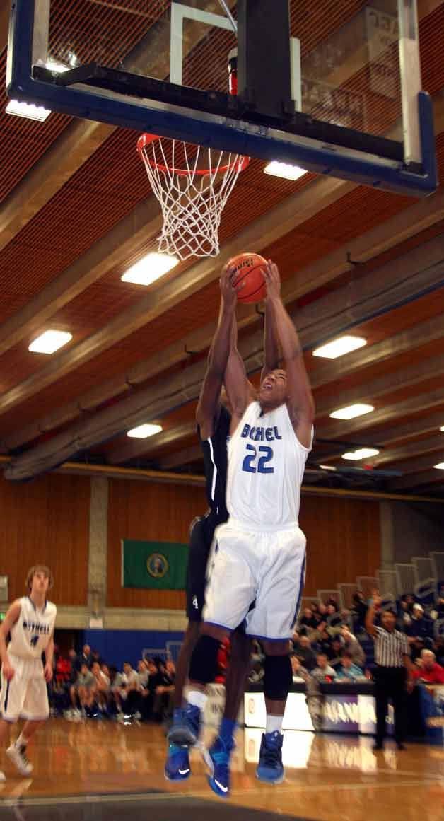 Peyton Cordova-Smith goes strong to the hoop with a Federal Player on his back attempting to block the shot on Monday during the King Holiday Hoopfest at Bellevue College.