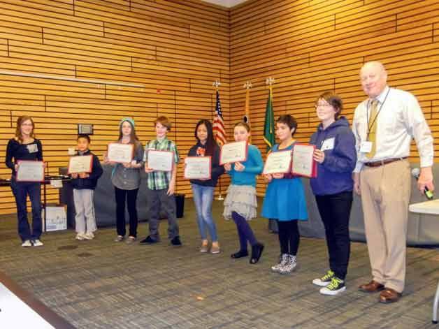 Arts of Kenmore President David Maehren presents local youth artists with certificates for their participation in the Youth Art Exhibit at Kenmore City Hall.