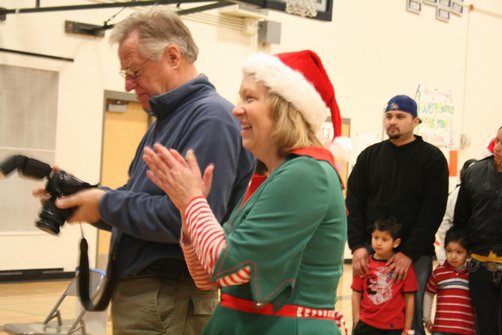 Mrs. Claus -- Norma Stoutenburg -- cheers after a child takes a picture with Santa Claus this morning at the Northshore Rotary's Santa Breakfast at Northshore Junior High. At left