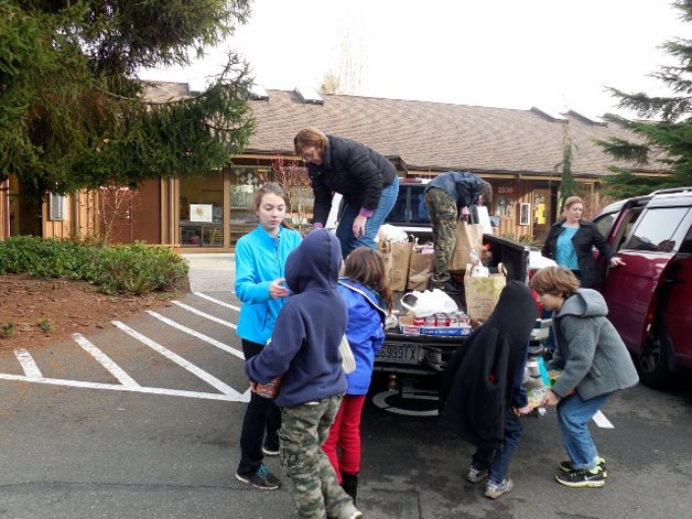 Students and families from Whole Earth Montessori School in Bothell spent two months collecting non-perishable food items for their annual community service project and food drive.