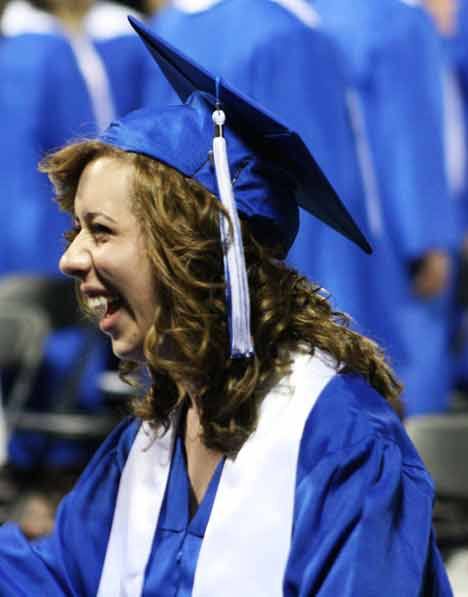 Bothell High's Kate Boles enters last night's graduation ceremony with a smile at University of Washington's Bank of America Arena.