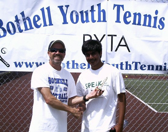 Bothell head tennis coach Michael Louis Pizzo congratulates Ayush Singh on his runner-up finish at last year's summer camps. Pizzo has been coaching tennis for over 25 years and will once again hold the Bothell Youth camps this summer at Bothell High School.