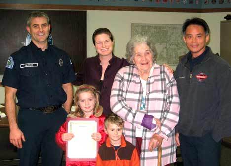 The Northshore Fire Department recently honored two Kenmore residents for the help they provided senior Louise Ford. Pictured here