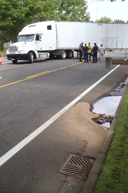 Crews clean up the diesel spill that occurred along North Creek Parkway S. in Bothell on July 24.