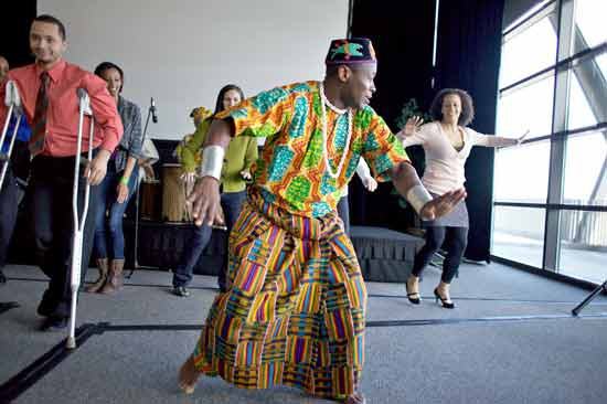 A performer dances with members of the audience