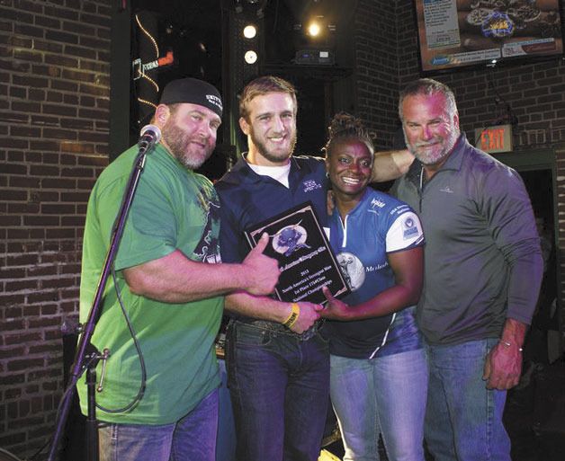 Bothell resident Patrick Castelli poses with friends after winning the Strongman National Championship.